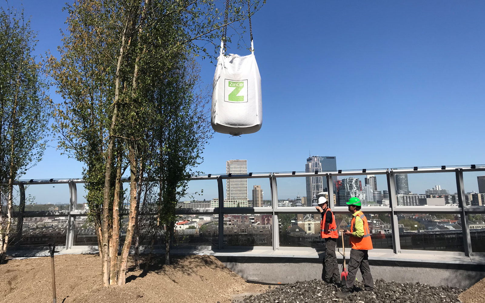The substrate and the trees both are lifted onto the roof with a telescopic crane. Substrate and trees are lifted onto the roof with a roof garden